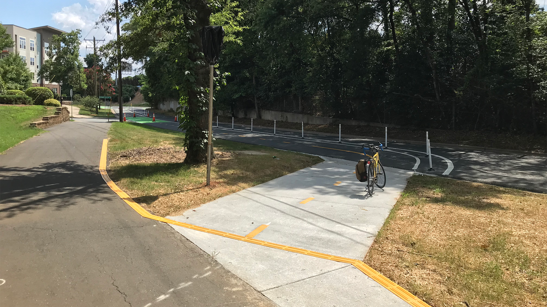 This bicycle ramp in Charlotte, NC considers how both people biking and people with visual disabilities will need to use the sidewalk space, with features that increase harmony between the two.