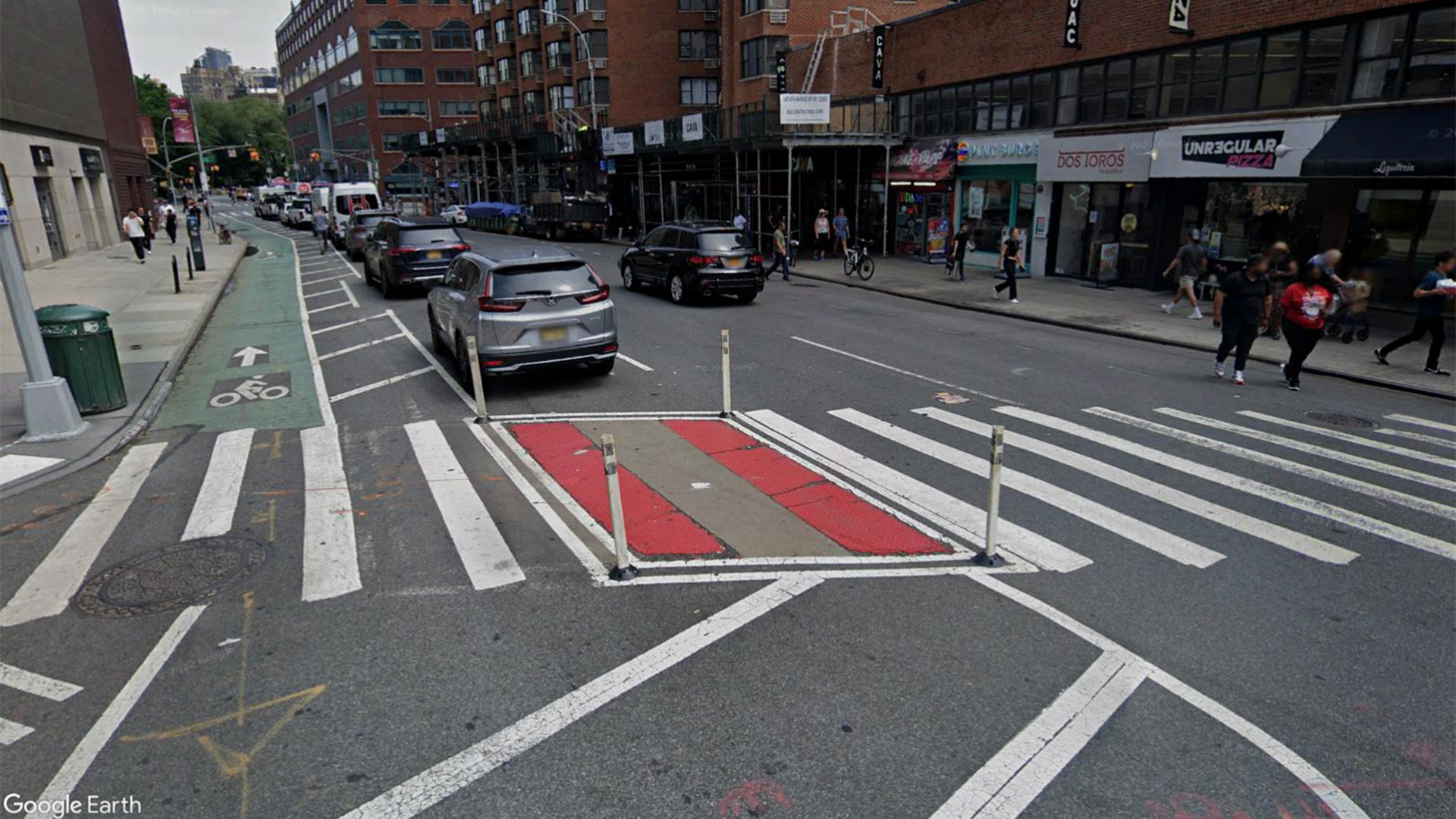 A crosswalk shortened from the use of a quick-build median