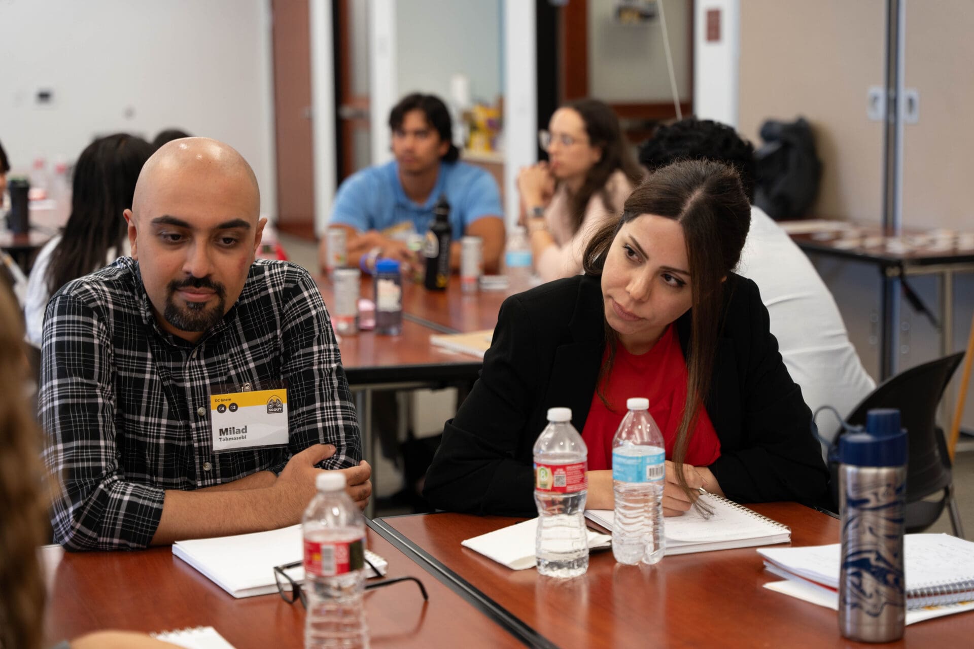 Two people sitting at a table conversing.