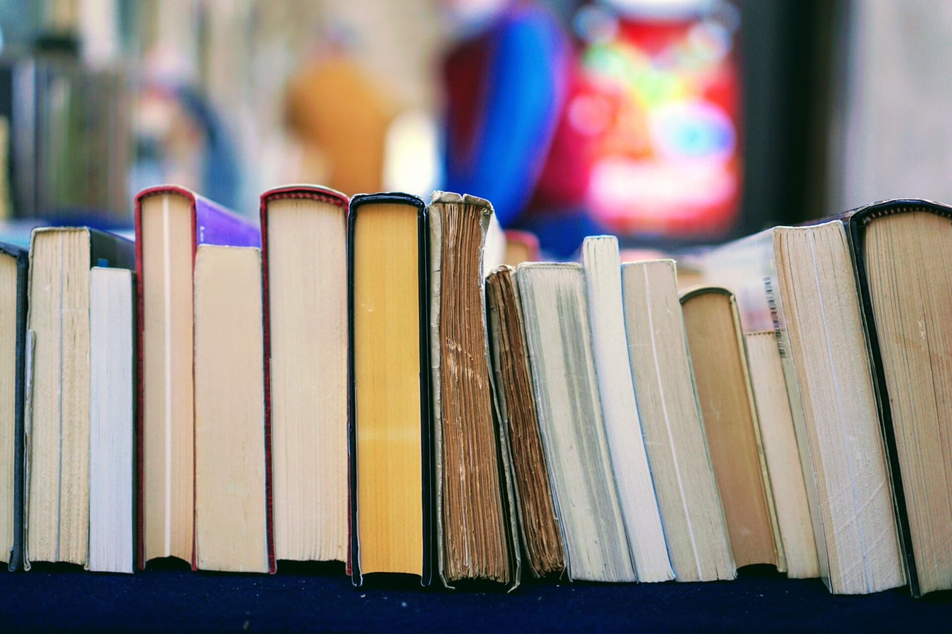 Stack of books laying on a table.