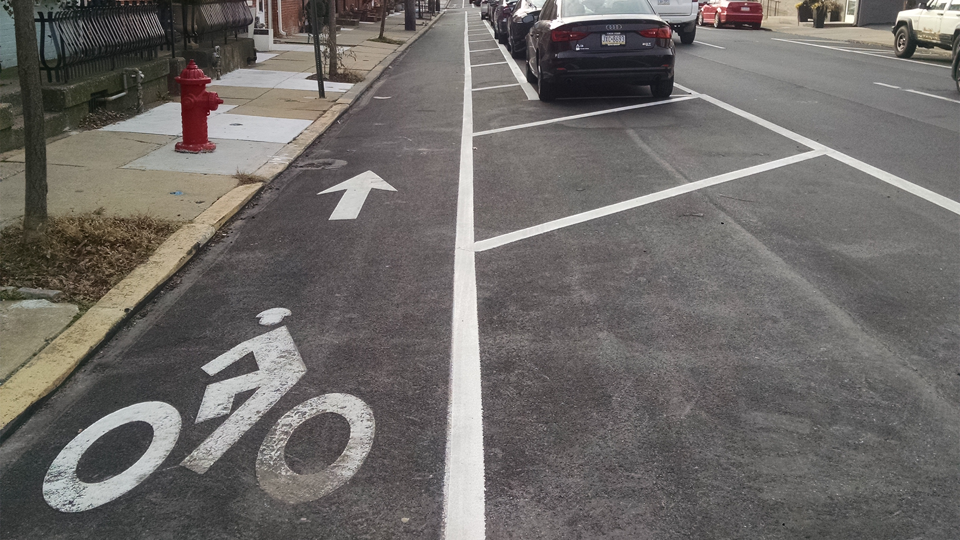 Image of bike lane on street with parking on the right.