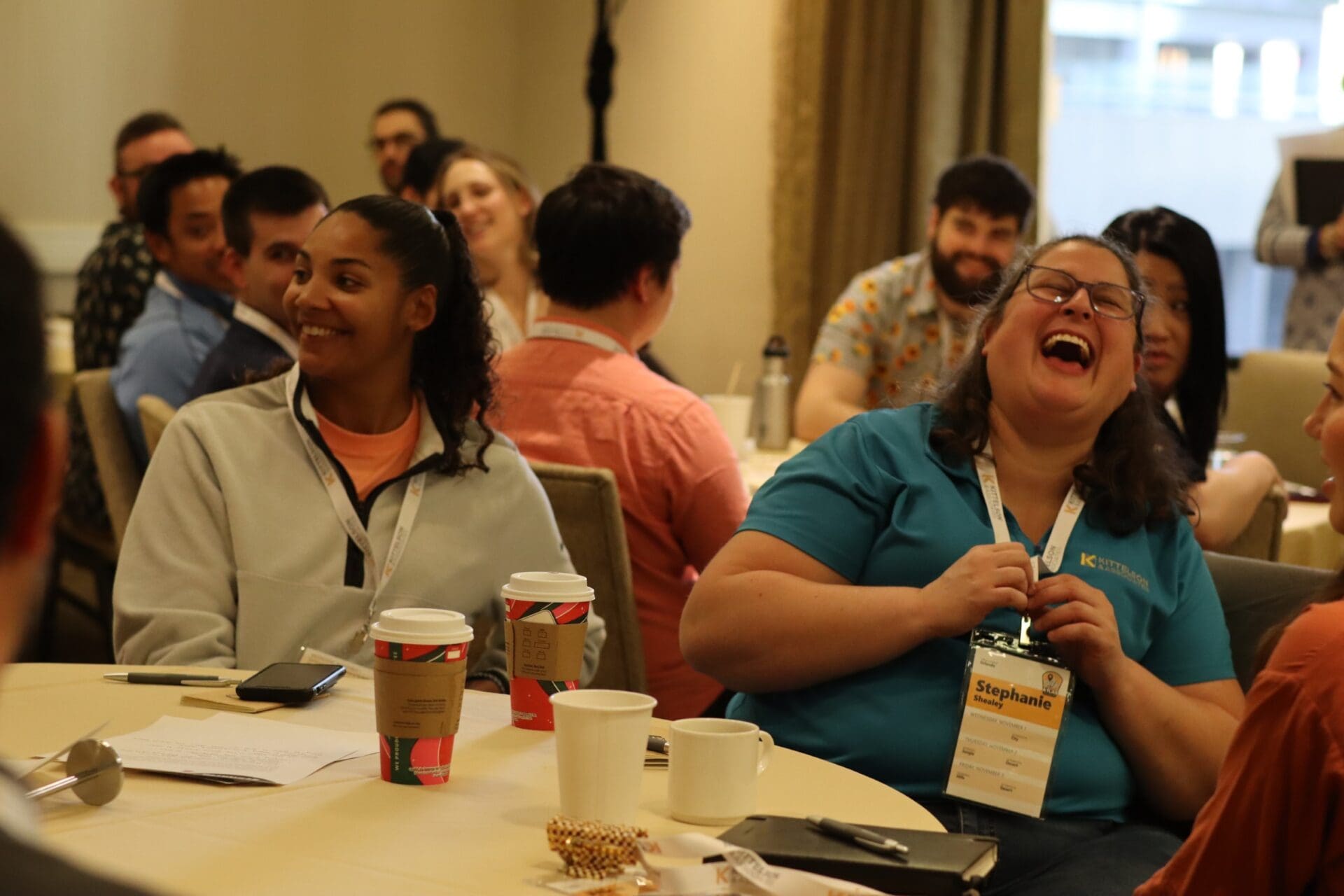 Person laughing at table