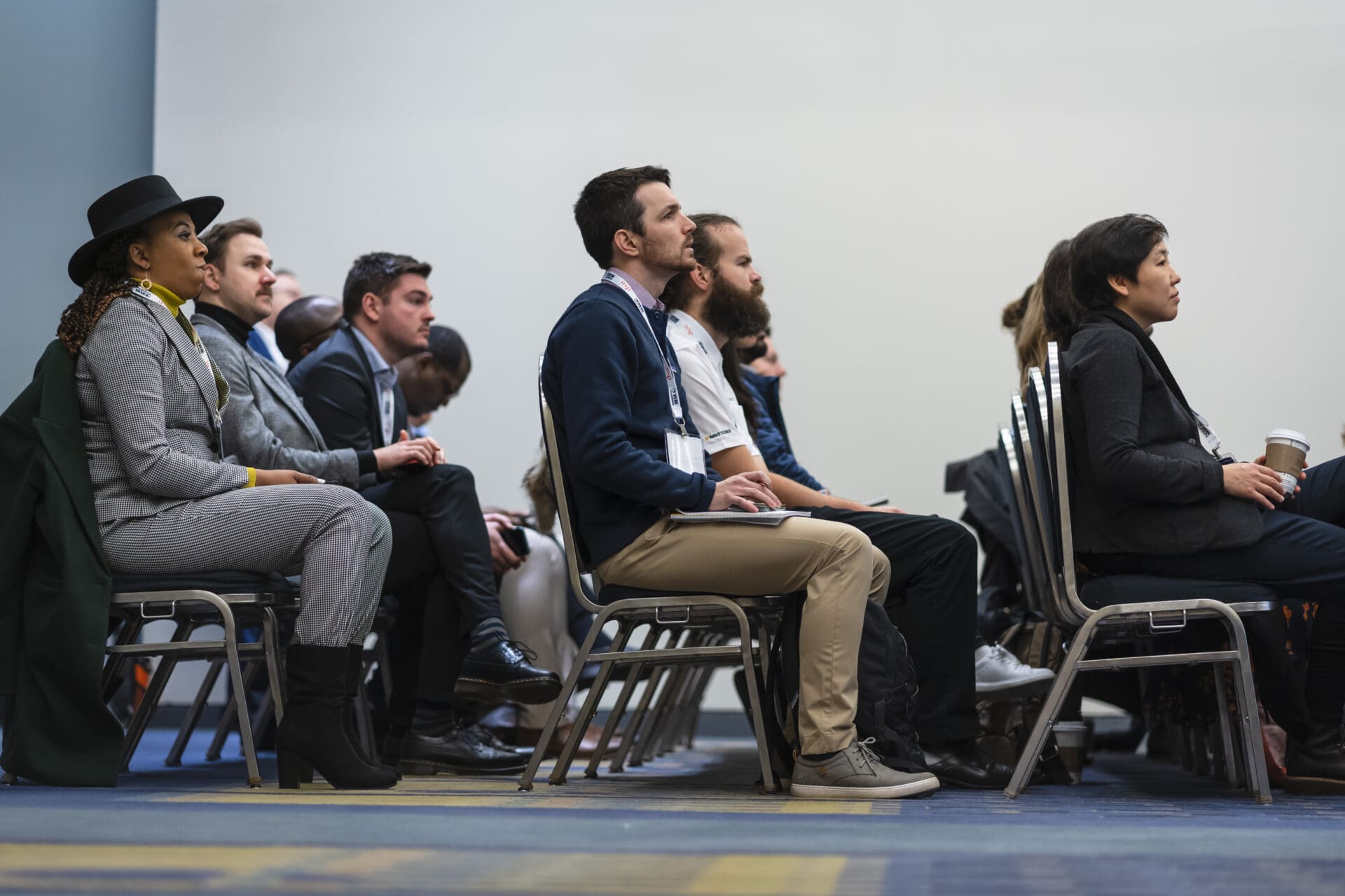 3 rows of people sitting in chairs facing the front of the room.