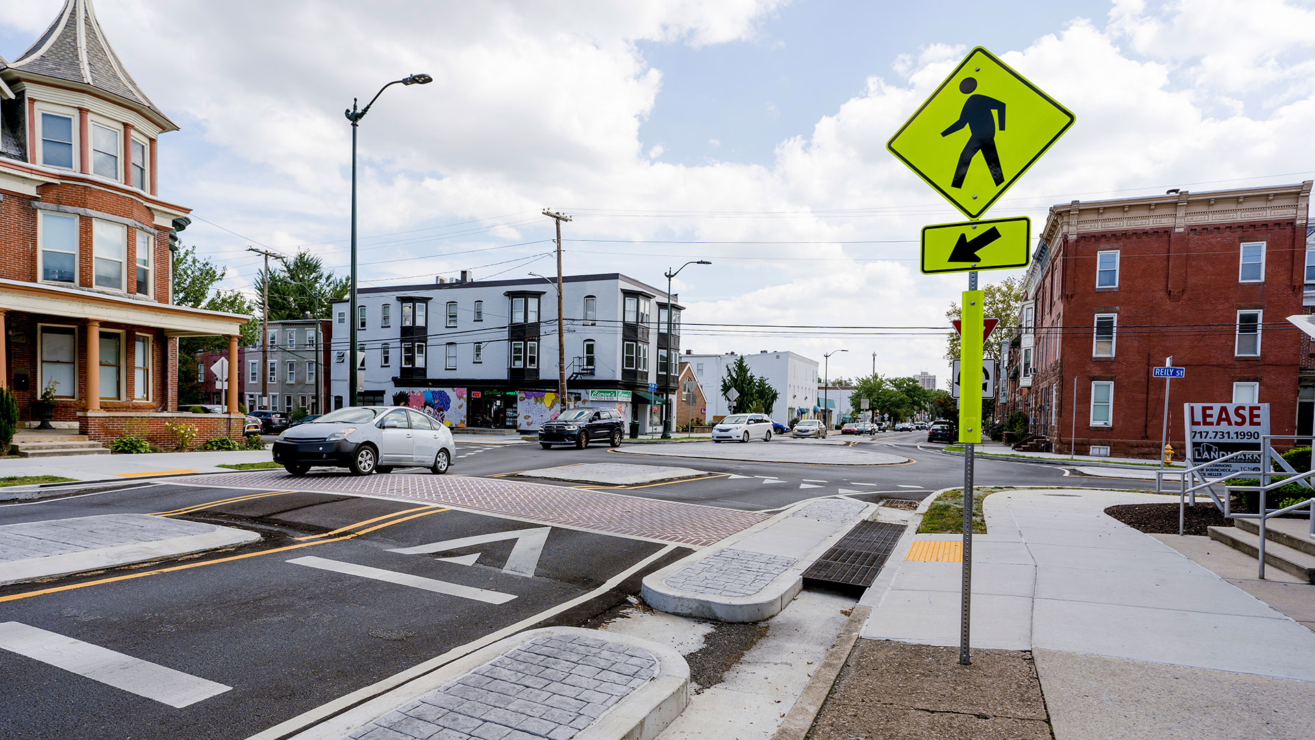 Street-level view of pedestrian crossing in front of roundabout