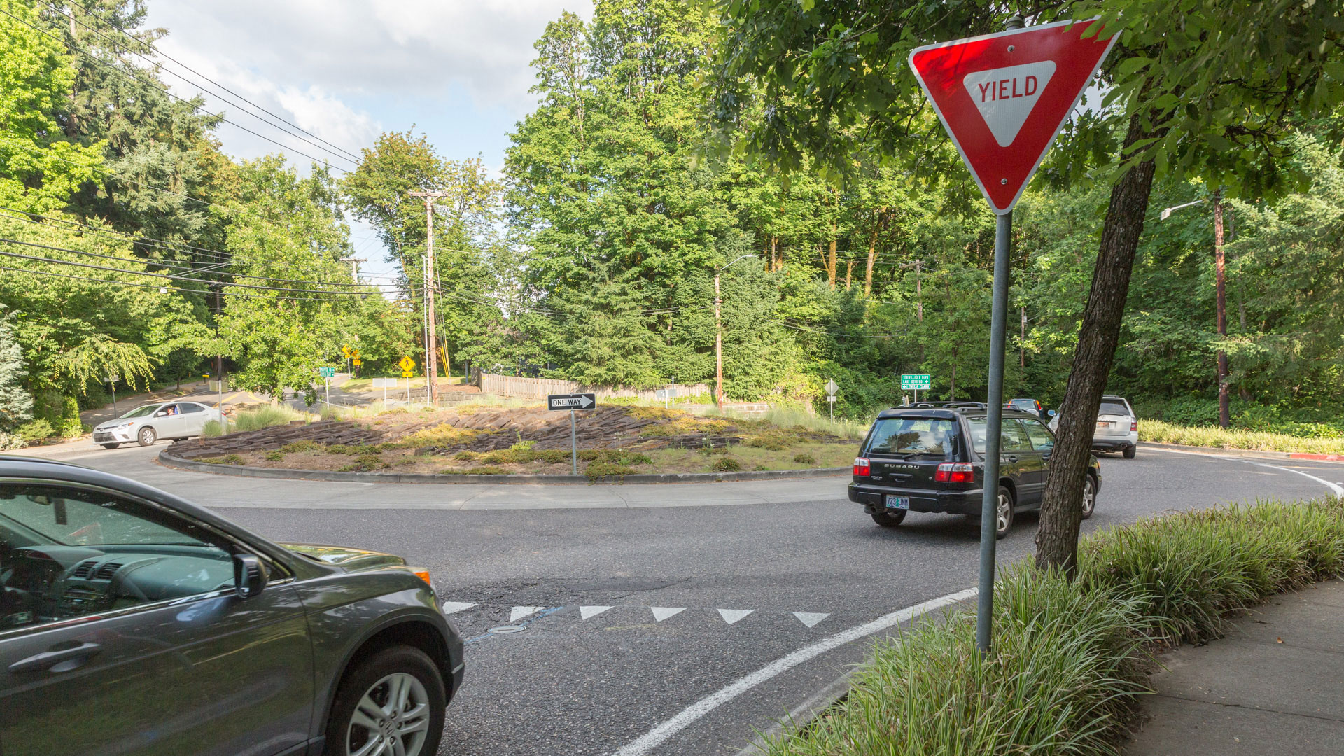 Street-level photo entering a single-lane roundabout.