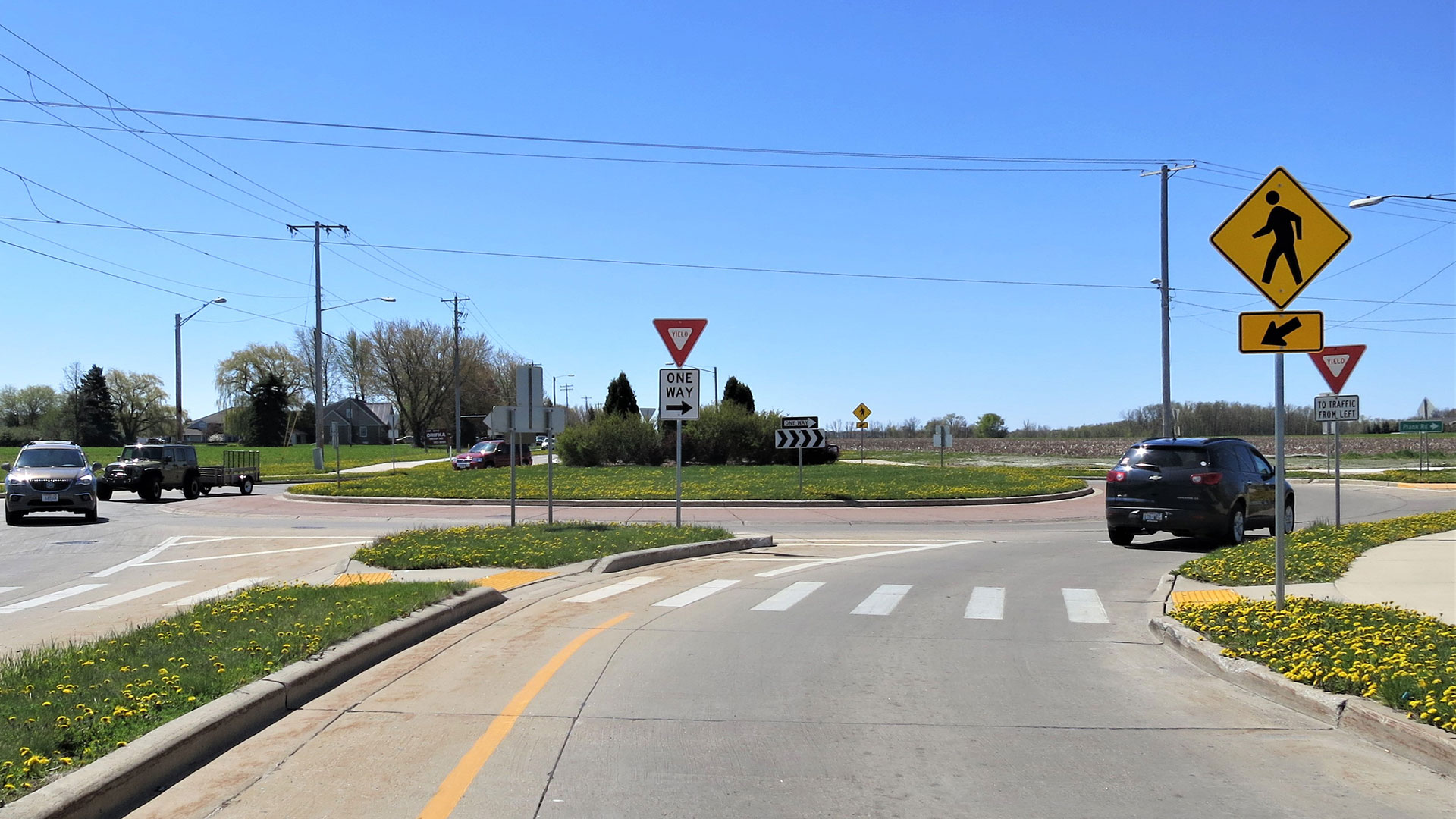 Streetview photo entering a single-lane roundabout.