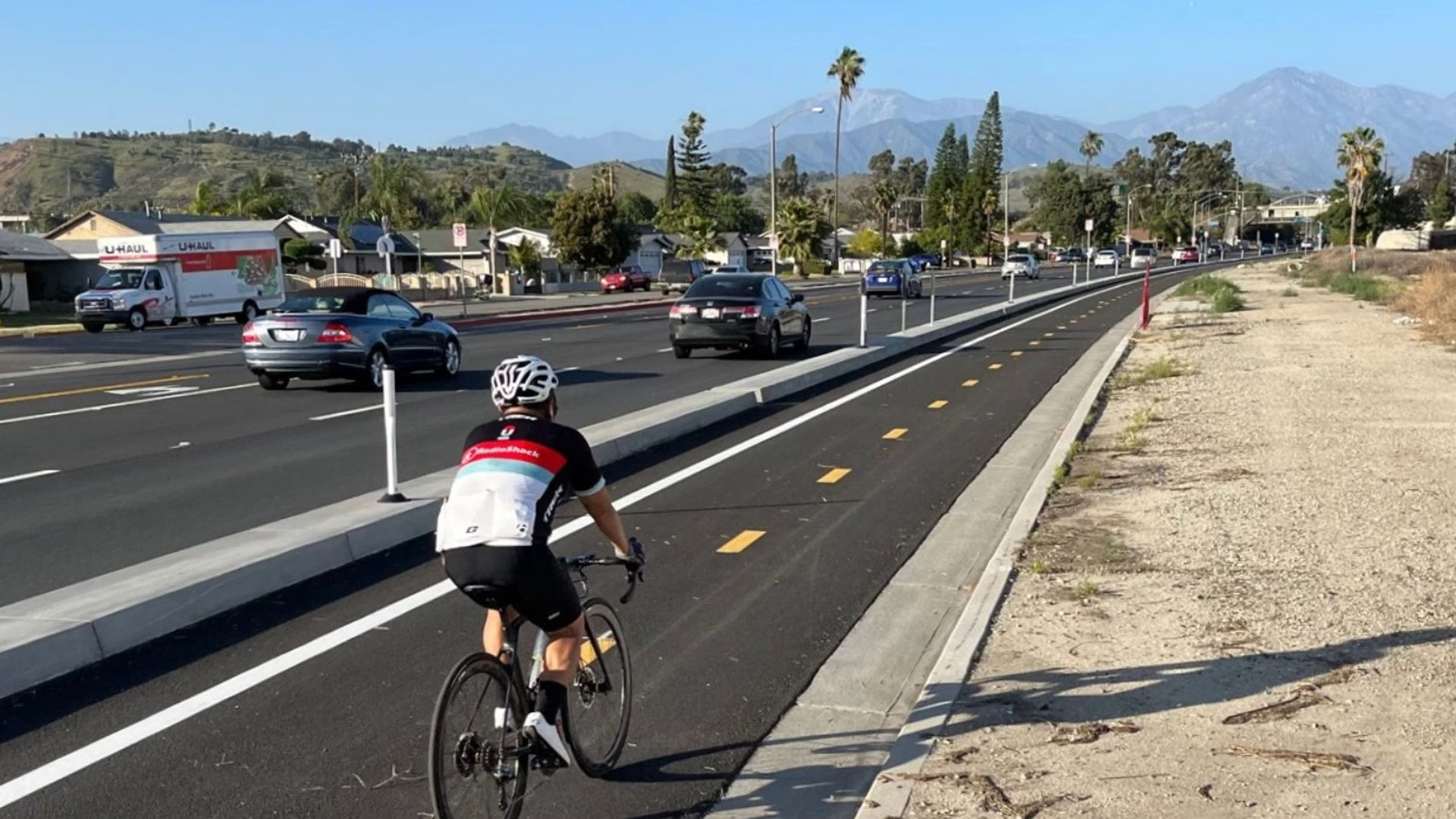 Bicyclist traveling down a separated bike lane in Pomona, California.