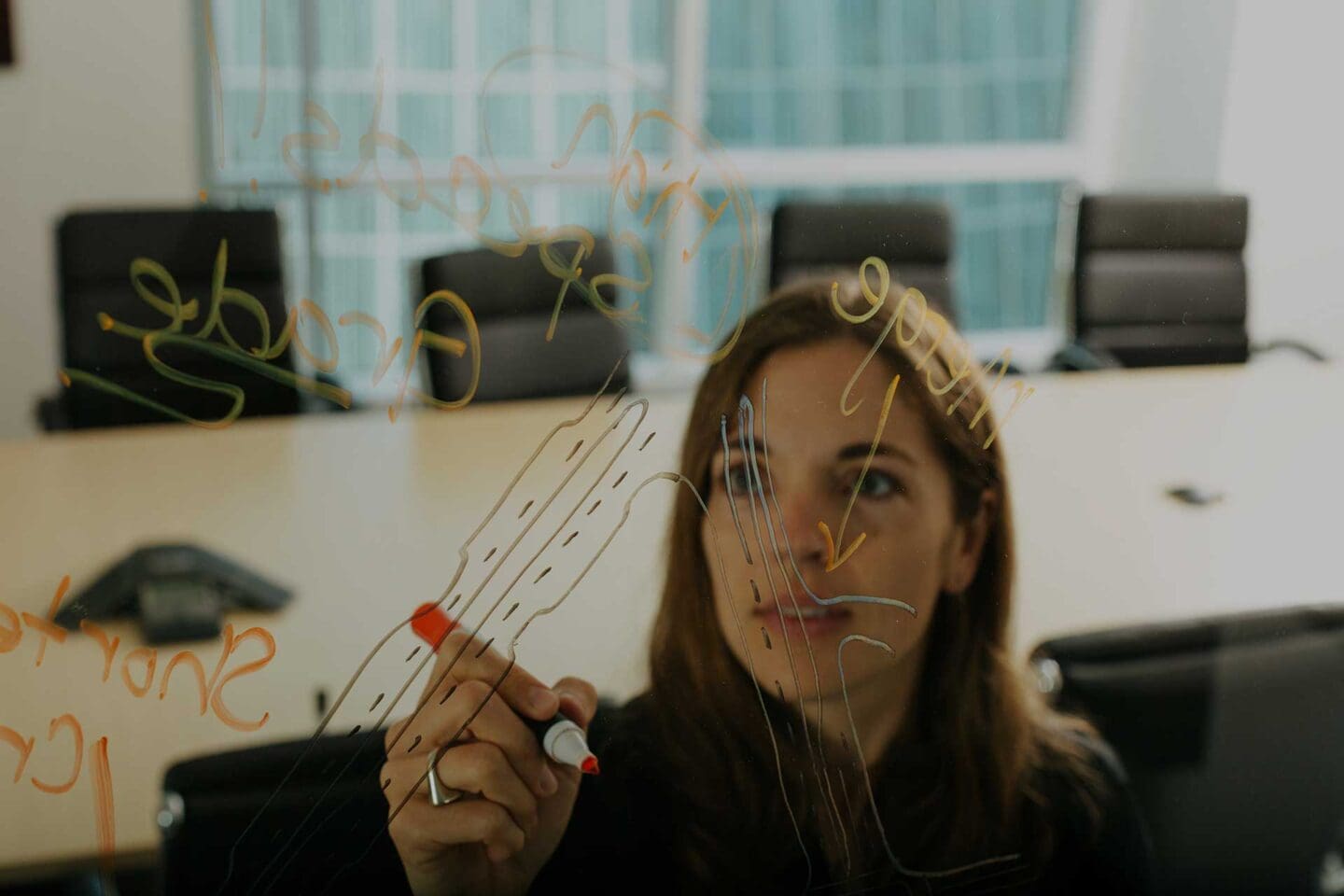 Woman drawing a roundabout on a whiteboard