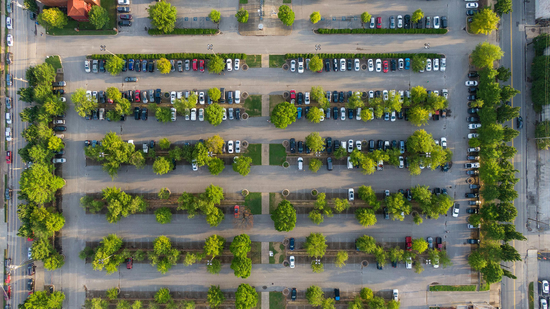 Aerial shot of large, mostly empty parking lot.