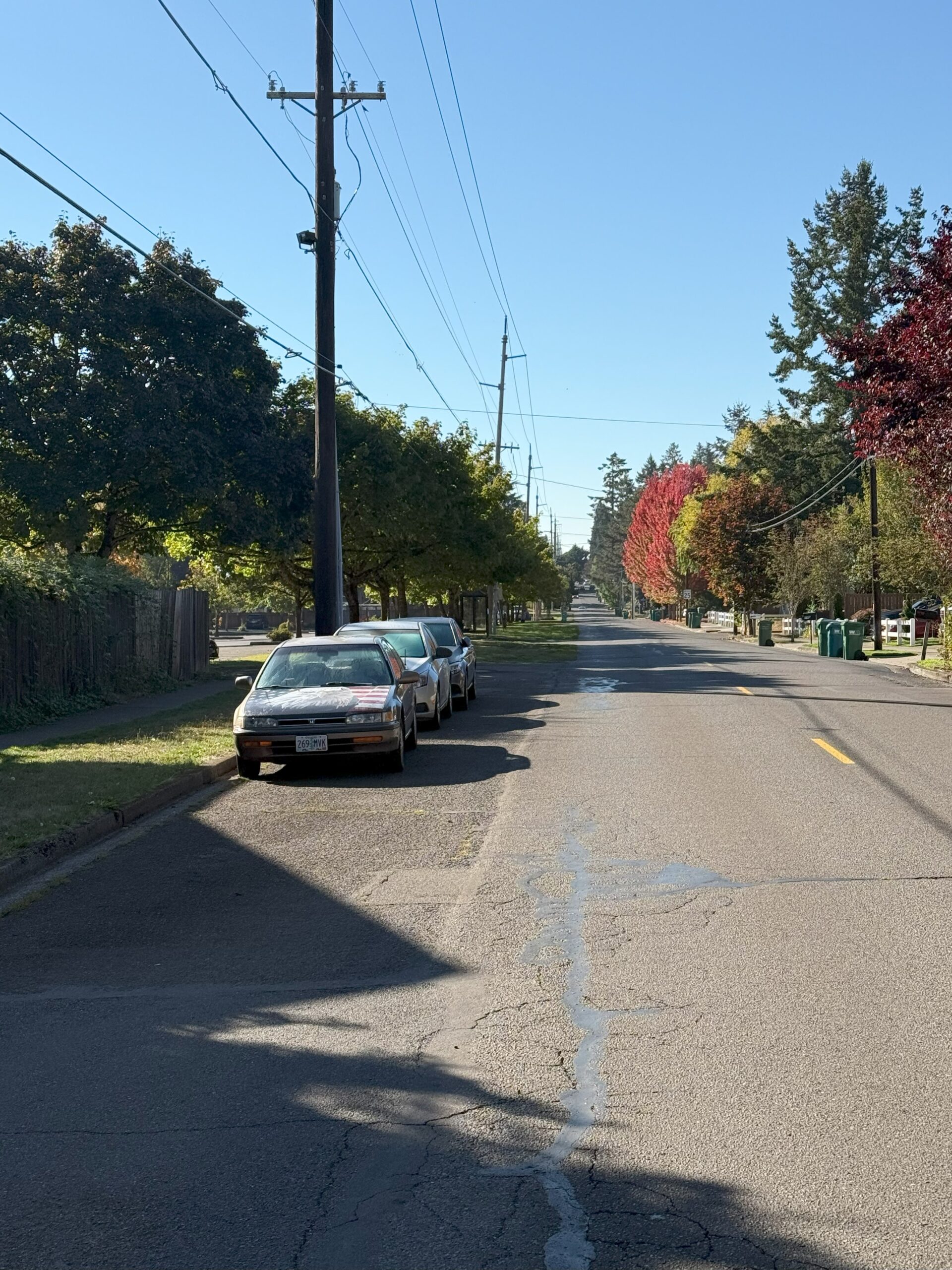 Road with cars parked on the side