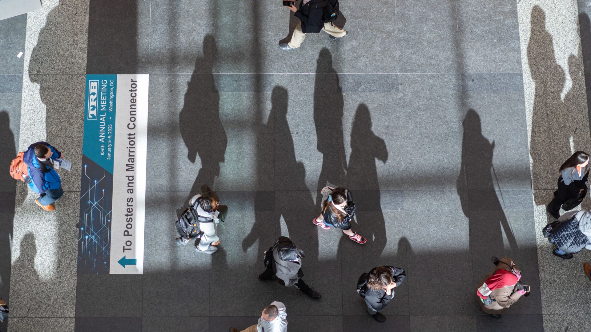 Aerial view of people walking in convention center.