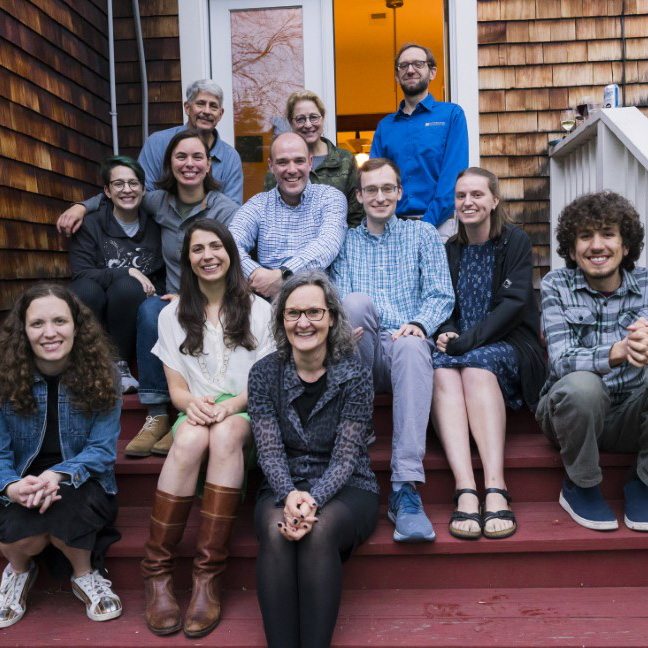 Group of people taking a photo on back porch steps