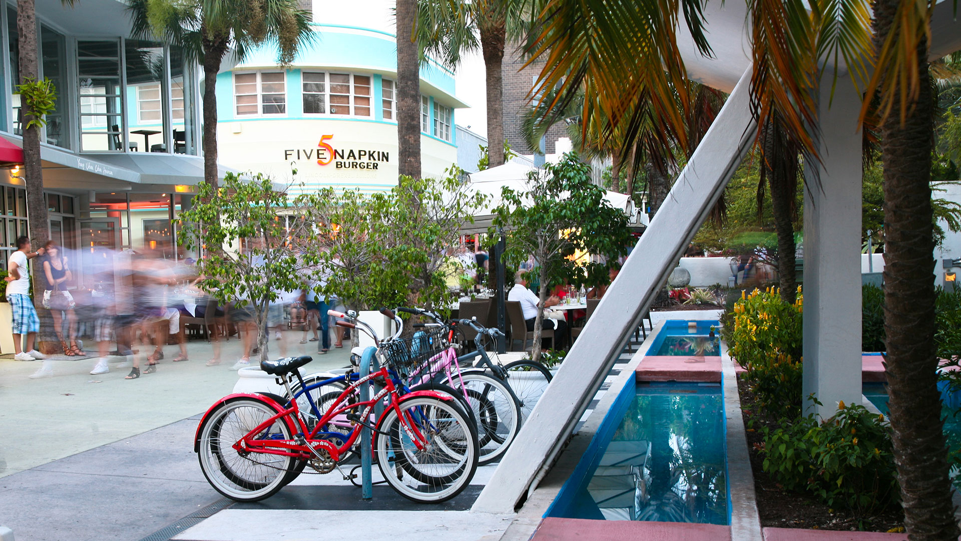 Outdoor mall with people walking and bikes parked on a bike rack