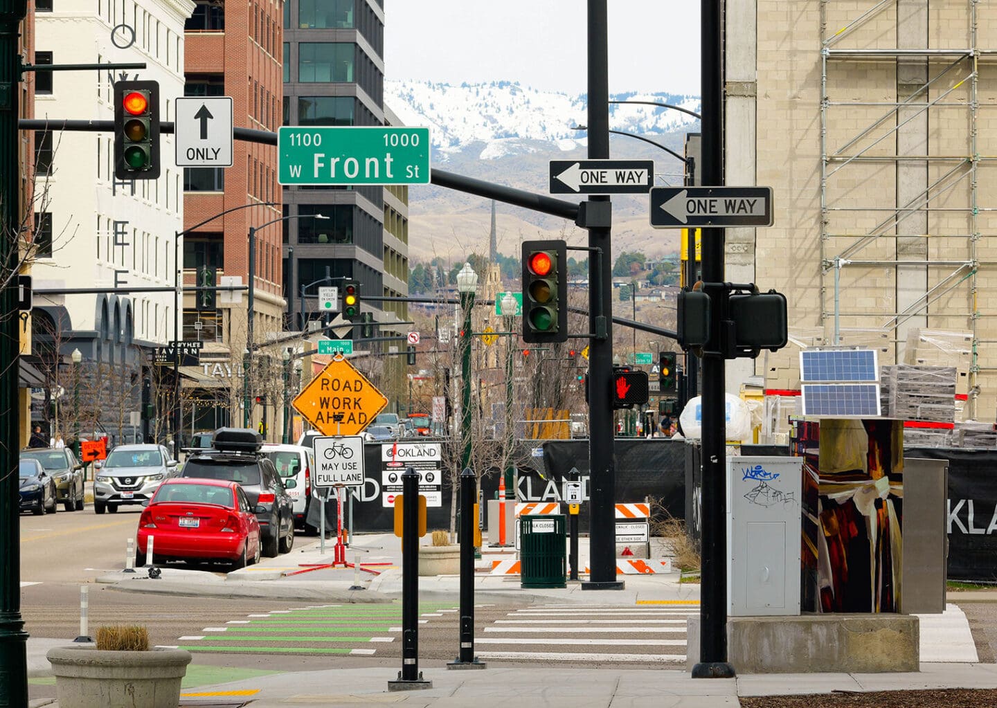 City street with bike lane, cross walk, and cars